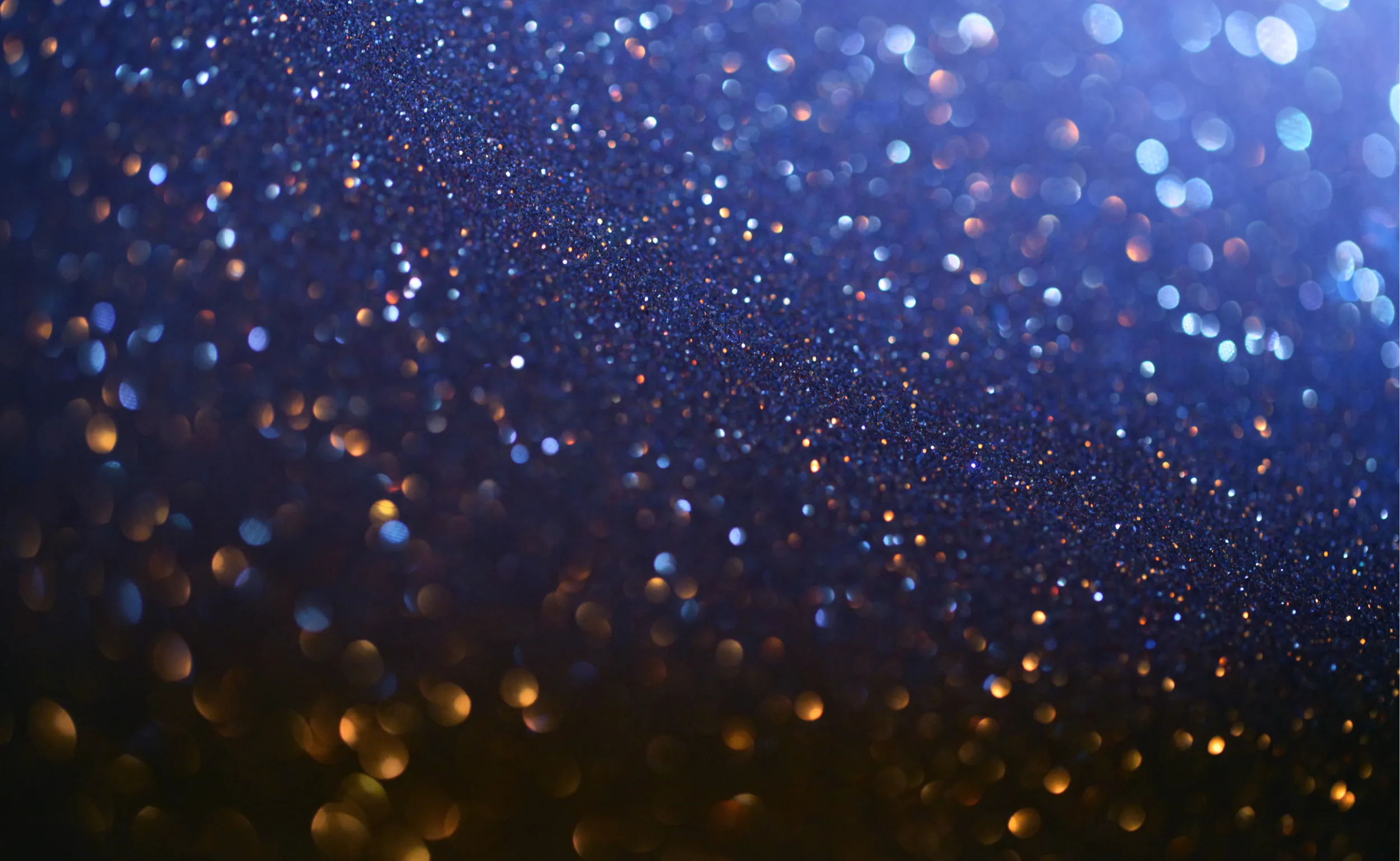 Particules dorées sur fond bleu nuit