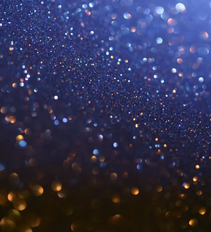 Particules dorées sur fond bleu nuit